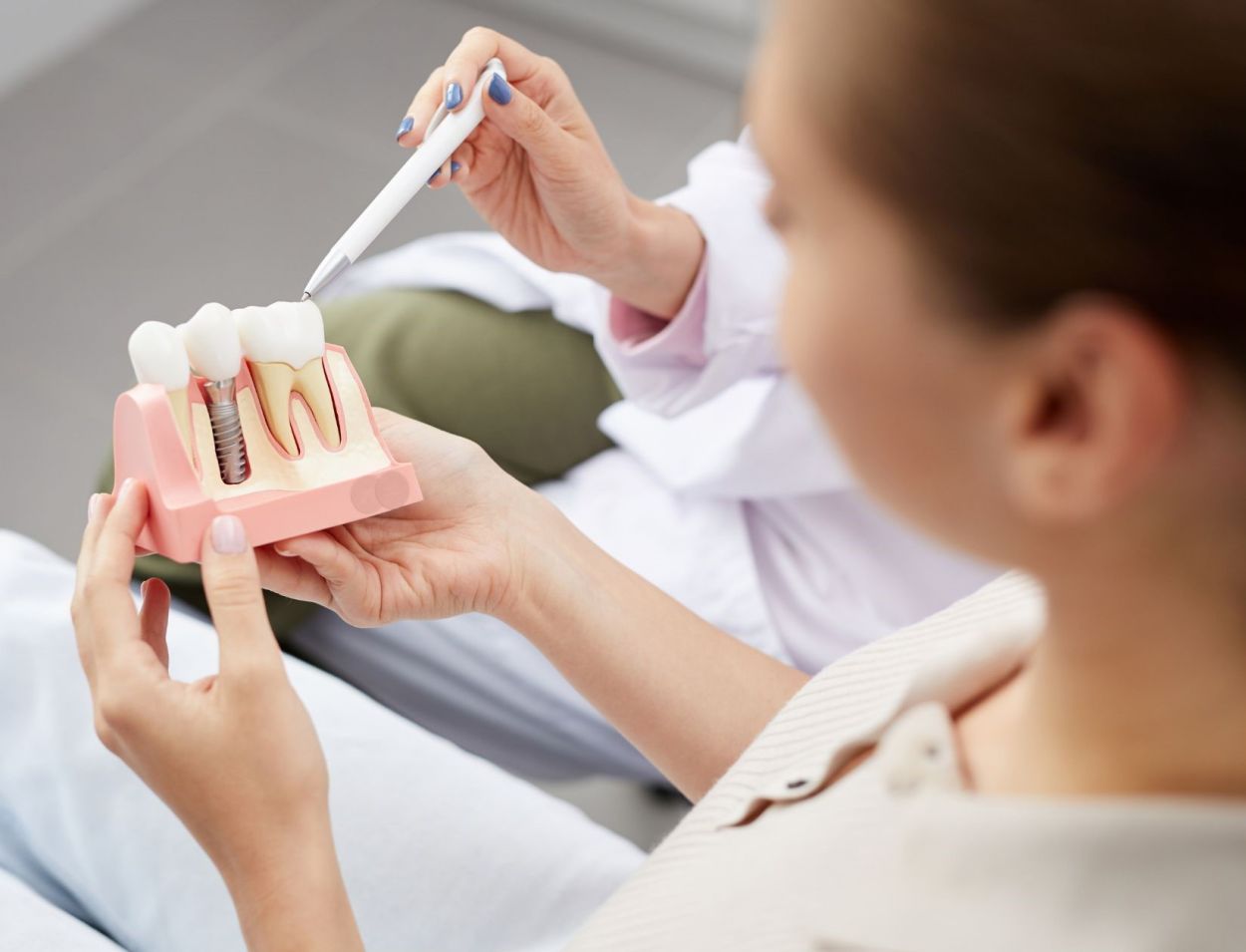Dentist talking through Implant treatment